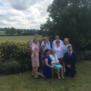 Marie in garden with family at 90